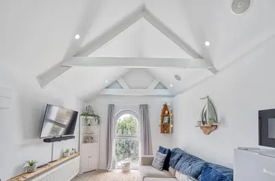 a living room with a couch and a window at Host & Stay - Sail Loft in Hayle