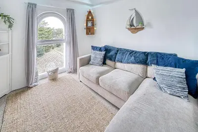 a living room with a couch and a window at Host & Stay - Sail Loft in Hayle