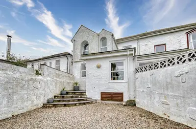 a white house with a gate and a fence at Host & Stay - Sail Loft in Hayle