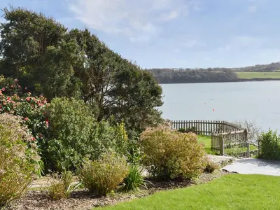 a garden with a view of a body of water at Bessborough in Saint Mawes