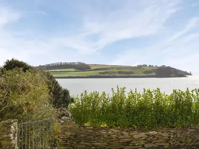 a view of a large body of water with a hill at Bessborough in Saint Mawes