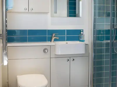 a bathroom with a sink and a toilet at Bessborough in Saint Mawes