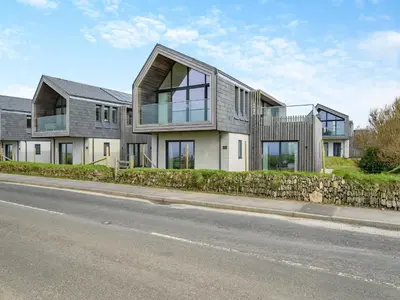 a house on the side of a road at 3 Karn Havos in Mawgan Porth