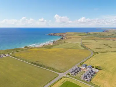 an aerial view of a house and the ocean at 3 Karn Havos in Mawgan Porth