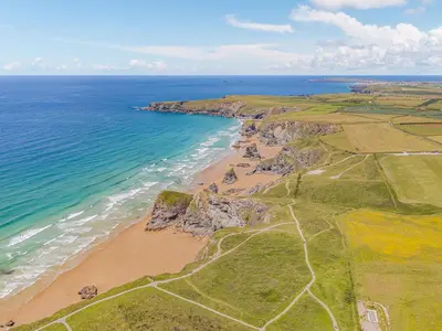 an aerial view of a beach and the ocean at 3 Karn Havos in Mawgan Porth