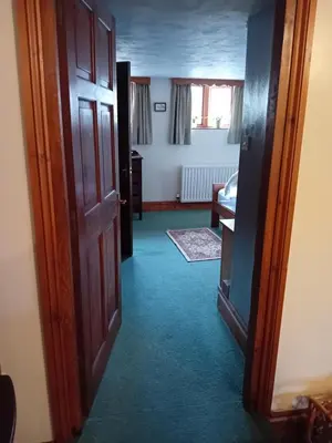 an open door to a room with a hallway at Robins Nest in Liskeard