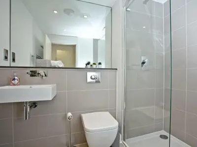 a bathroom with a shower and a toilet and a sink at 15 Ocean Gate Newquay in Crantock