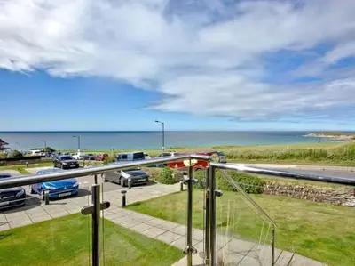 a view of the ocean from the balcony of a house at 15 Ocean Gate Newquay in Crantock