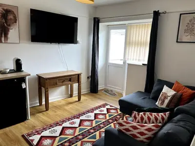 a living room with a couch and a table at Flat in the heart of Newquay in Newquay