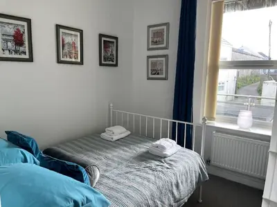 a bedroom with a bed with two towels on it at Flat in the heart of Newquay in Newquay
