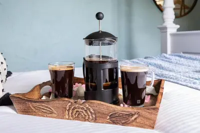 a tray with two glasses of coffee and a blender at Treworgie Barton Cottages - Chappell in Bude