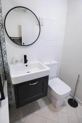 a bathroom with a sink and a mirror and a toilet at Treworgie Barton Cottages - Chappell in Bude