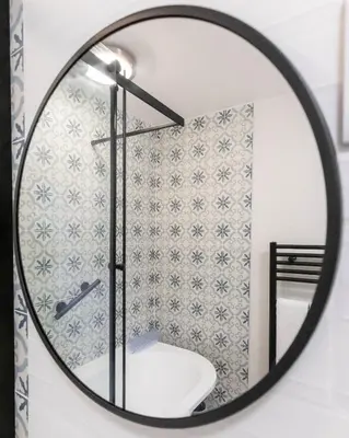 a bathroom mirror with a sink and a toilet at Treworgie Barton Cottages - Chappell in Bude