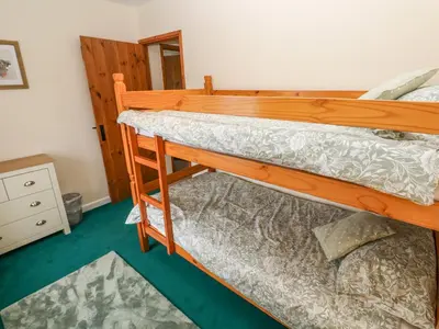 a pair of bunk beds in a room at Swallow Cottage in Helston