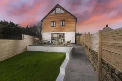 a home with a wooden fence and a yard at Atlantic Point, Porthleven - Free WiFi & Parking - Coffee Machine - Close to Harbour & Town in Porthleven