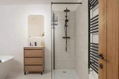 a shower with a glass door in a bathroom at Atlantic Point, Porthleven - Free WiFi & Parking - Coffee Machine - Close to Harbour & Town in Porthleven