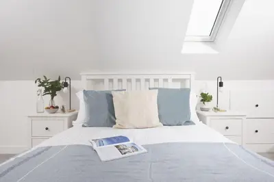 a bedroom with a bed with a book on it at Atlantic Point, Porthleven - Free WiFi & Parking - Coffee Machine - Close to Harbour & Town in Porthleven