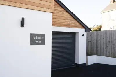 a garage door with a sign that reads automatic paint at Atlantic Point, Porthleven - Free WiFi & Parking - Coffee Machine - Close to Harbour & Town in Porthleven