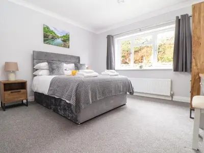 a bedroom with a bed and a window at Lakeside in Falmouth