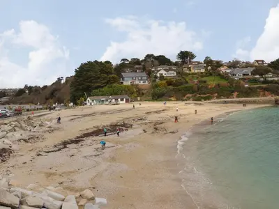 a group of people on a beach near the water at Lakeside in Falmouth