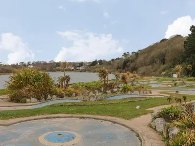 a garden with a lake in the background at Lakeside in Falmouth