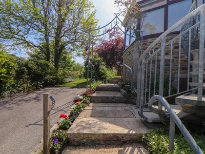 a garden with flowers on the side of a building at Lakeside in Falmouth