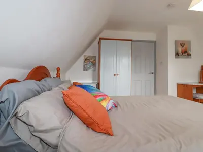 a bedroom with a bed with two pillows on it at Rainbow Lodge in Bodmin