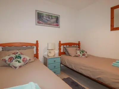 two beds sitting next to each other in a bedroom at Rainbow Lodge in Bodmin
