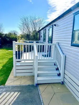a house with a white staircase next to a house at The Beach Retreat in Par