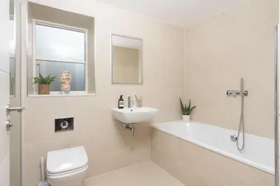 a bathroom with a sink and a tub and a toilet at Sandyford, Holywell Bay - Sea Views - Walk to Beach - 2 Pets Allowed - Free Parking and WiFi in Holywell Bay