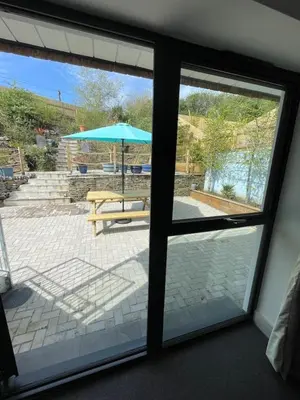 a view of a patio through a sliding glass door at Gulland 4 Bed Sleeps 8 with Hot tub in Treknow