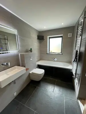 a bathroom with a tub and a toilet and a sink at Gulland 4 Bed Sleeps 8 with Hot tub in Treknow