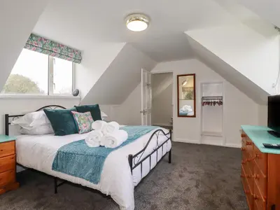 a bedroom with a bed with towels on it at The Retreat in Bodmin