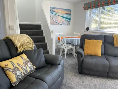 a living room with a couch and a table at The Retreat in Bodmin
