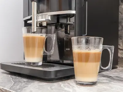 two glasses of coffee sitting on top of a coffee maker at Swans Nest in Falmouth