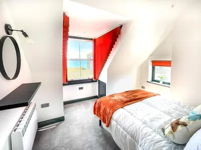 a bedroom with a bed and a window with the ocean at 2 Bed in St. Ives oc-r28154 in St Ives