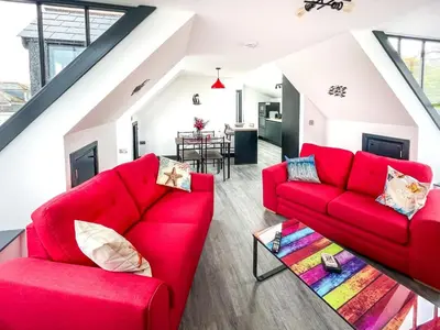 a living room with red couches and a table at 2 Bed in St. Ives oc-r28154 in St Ives