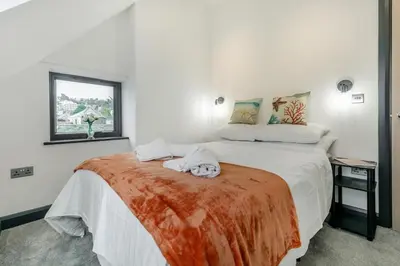 a bedroom with a bed with two towels on it at 2 Bed in St. Ives oc-r28154 in St Ives