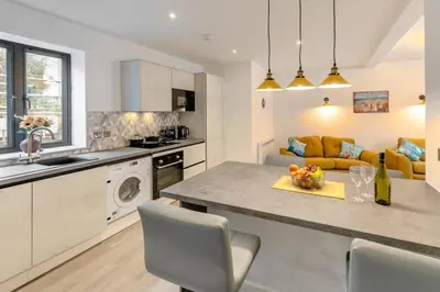 a kitchen and living room with a table and a couch at 2 Bed in St. Ives oc-s28155 in St Ives