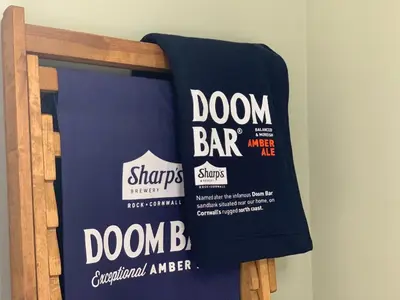 a pair of towels hanging on a rack at Halfway House Inn in Wadebridge