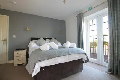 a bedroom with a bed with white towels on it at Halfway House Inn in Wadebridge