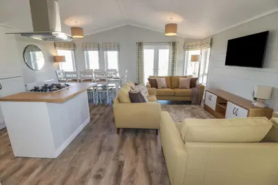 a large living room with a kitchen and a living room at 4 Meadow Retreat in Liskeard