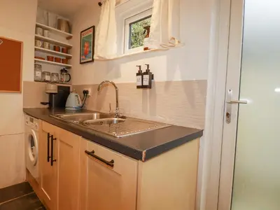 a kitchen with a sink and a counter top at Waterside Cottage in Truro