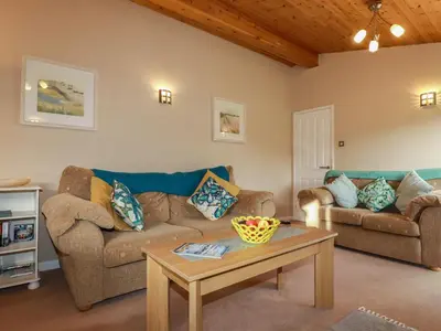 a living room with a couch and a table at 4 The Glade in Wadebridge