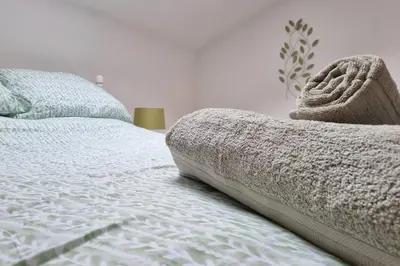 a bed with a blanket on it in a bedroom at Stable Barn Apartment in Saint Breward