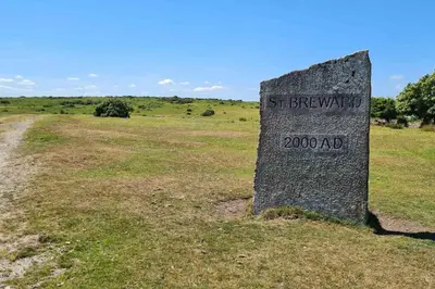 a stone sign in the middle of a field at Stable Barn Apartment in Saint Breward
