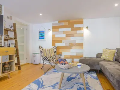 a living room with a couch and a table at Apartment Tintagel Sea view by Interhome in Treknow