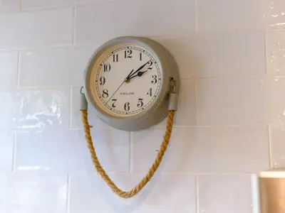 a clock hanging on a wall with a rope at Apartment Tintagel Sea view by Interhome in Treknow