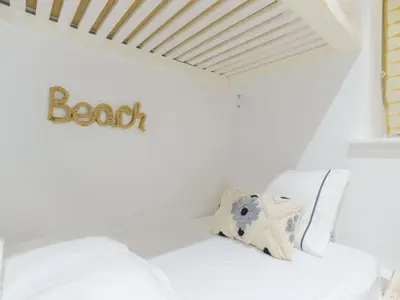 a bedroom with a bed with a sign on the wall at Apartment Tintagel Sea view by Interhome in Treknow