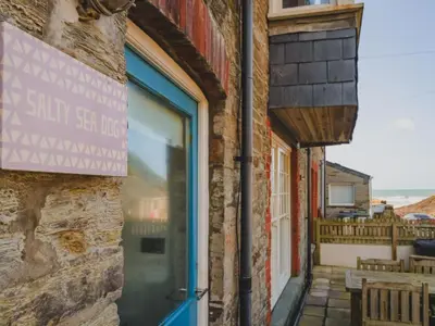 a door to a brick building with a sign on it at Apartment Tintagel Sea view by Interhome in Treknow